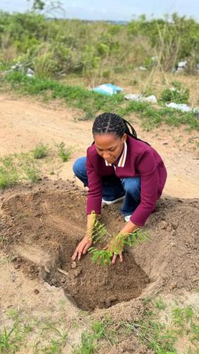 Lidya John planting a tree